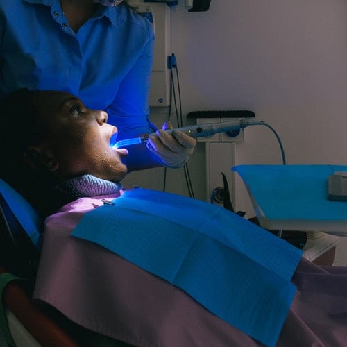 pexels-anna-shvets-3845709 Dentist checking teeth with blue rays